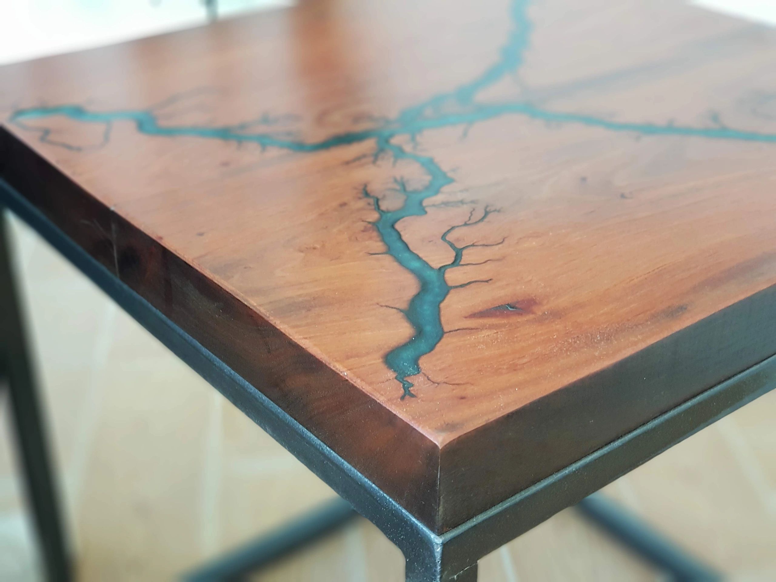 Live-edge wood and blue epoxy tabletop detail